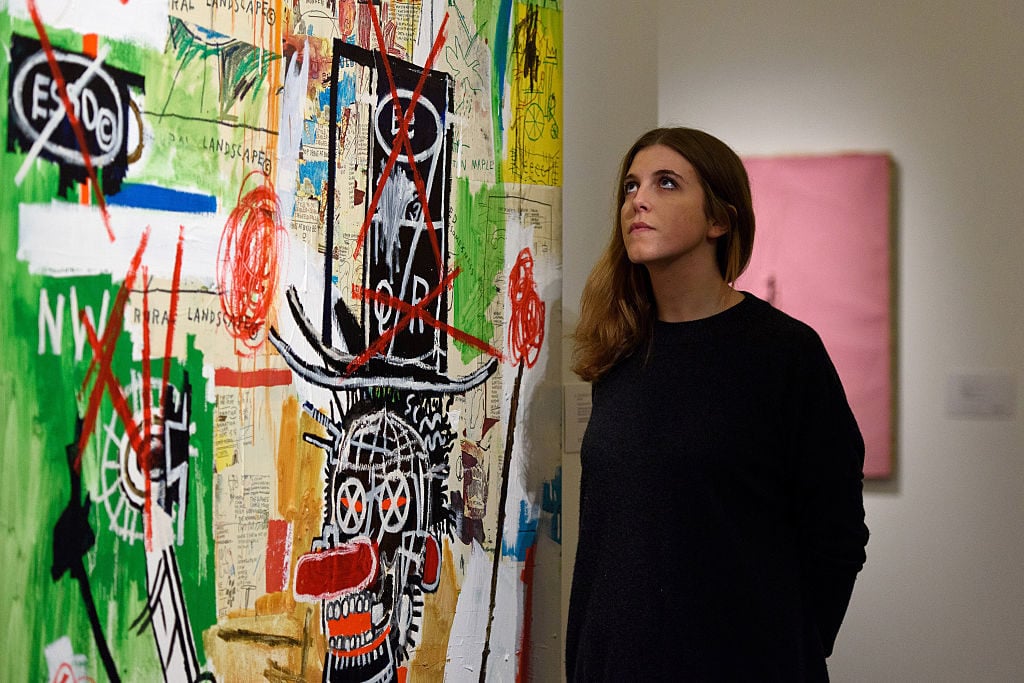 A gallery assistant views Despues De Un Puno by Jean Michael Basquiat which is expected to fetch 6 to 8 million GBP at Sotheby's on January 28, 2016 in London, England. Photo by Ben Pruchnie/Getty Images.