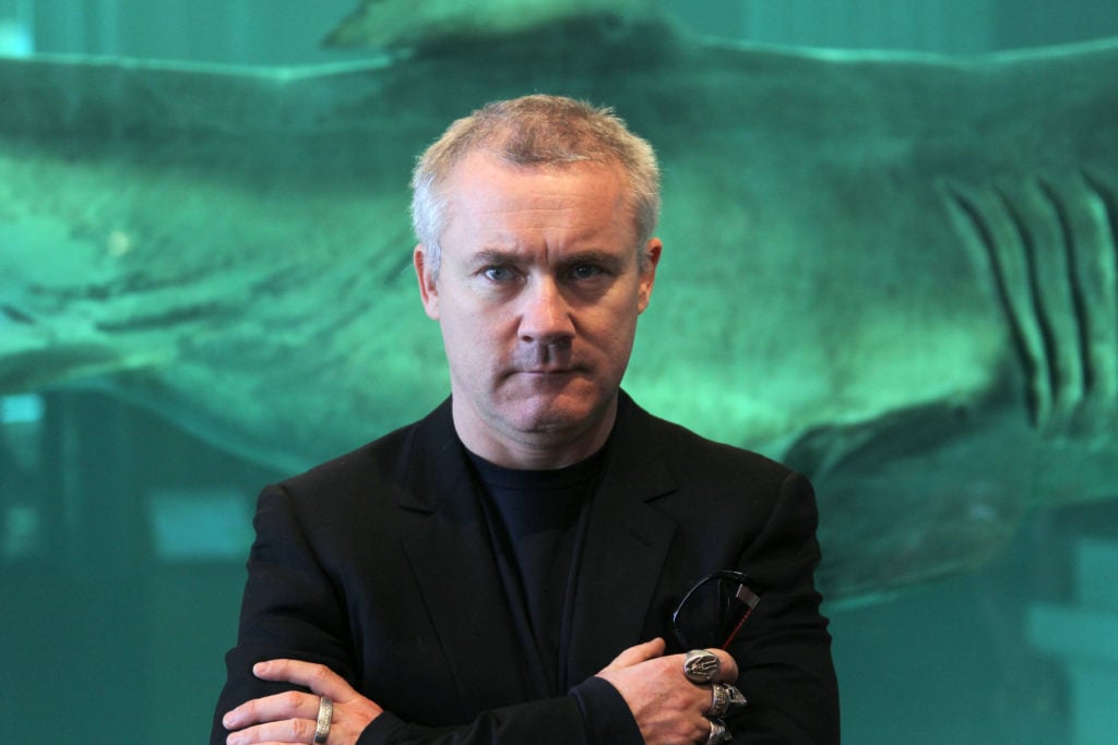 British artist Damien Hirst poses before his creation The immortal (1999) in 2010. Photo by Valery Hache/AFP/Getty Images.