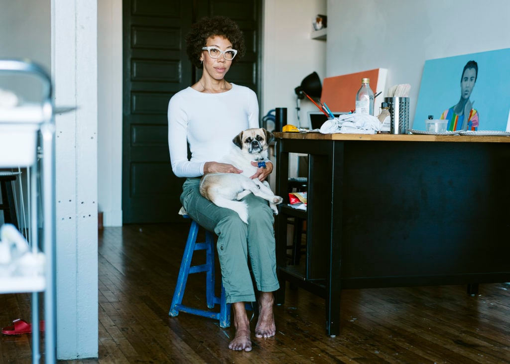 Artist Amy Sherald at her Baltimore, Maryland studio with her dog August. Photo courtesy the artist and Justin T. Gellerson.