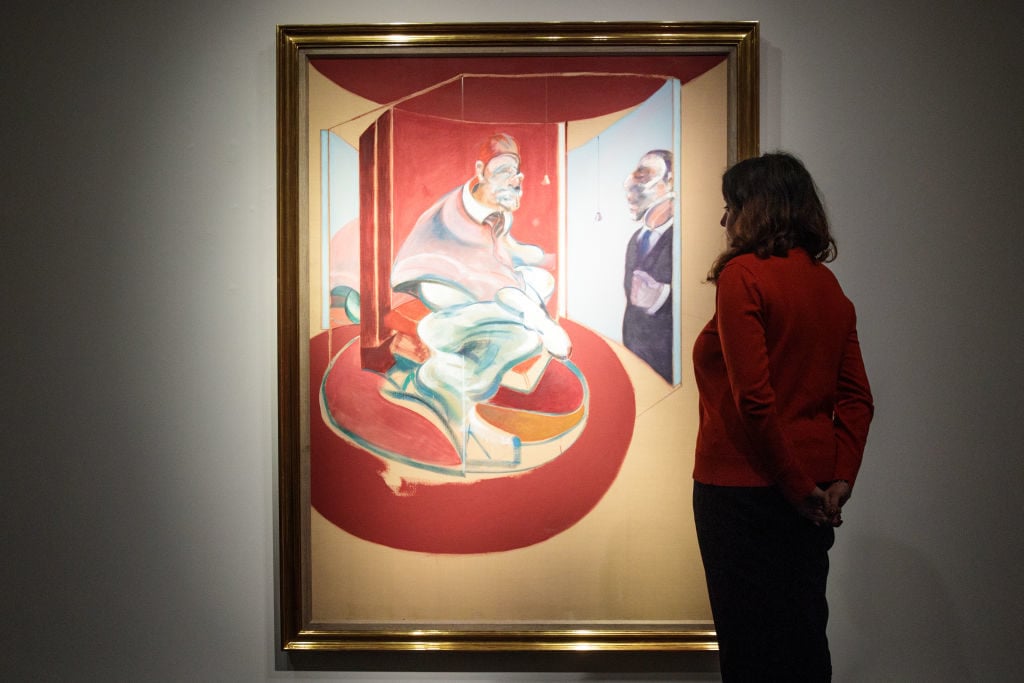 A Christie's employee poses with Study of a Red Pope, 1962. 2nd Version 1971 by Francis Bacon at Christie's on September 15, 2017 in London, England. Photo by Jack Taylor/Getty Images.