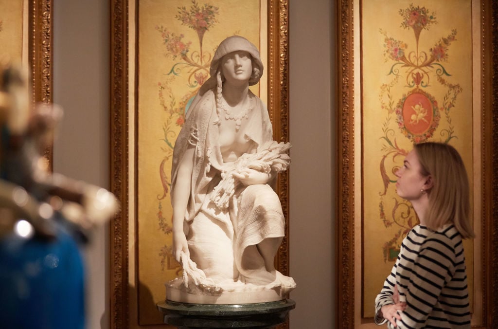 A member of Sotheby's observes Professore Rossi's white marble sculpture <em>Ruth</em> (est. £30,000-50,000), at Sotheby's on May 19, 2017 in London, England. Photo by Michael Bowles/Getty Images for Sotheby's.