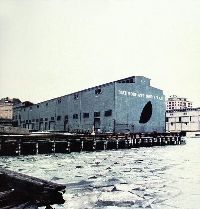 Gordon Matta-Clark, Day’s End (Pier 52) (Exterior with Ice), 1975, created by slicing holes in the exterior of a shed on Manhattan’s Pier 52. Photo courtesy of the Estate of Gordon Matta-Clark, Artists Rights Society (ARS), New York.