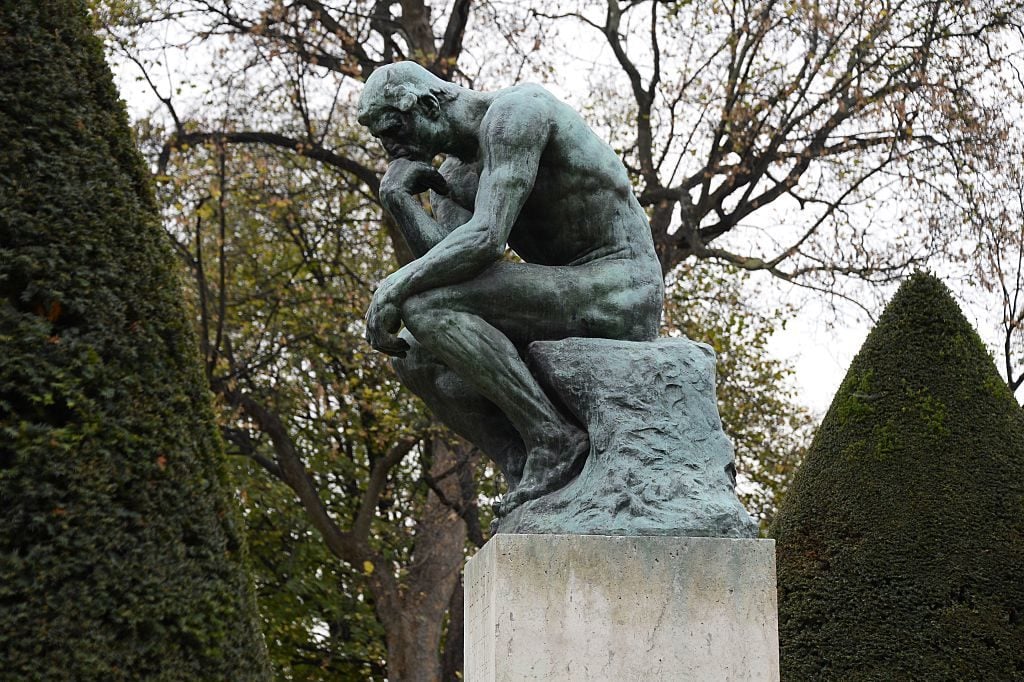 A cast of Auguste Rodin's The Thinker (Le Penseur) in the garden of the Musée Rodin in Paris on November 12, 2015. Photo by Bertrand Guay/AFP/Getty Images.
