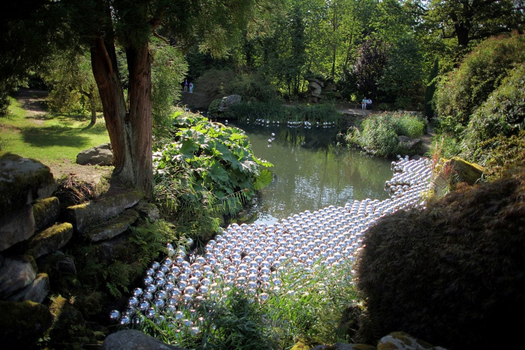 Narcissus Garden by artist Yayoi Kusama adorns the garden pond of Chatsworth House in 2009, Chatsworth, England. Photo by Christopher Furlong/Getty Images.