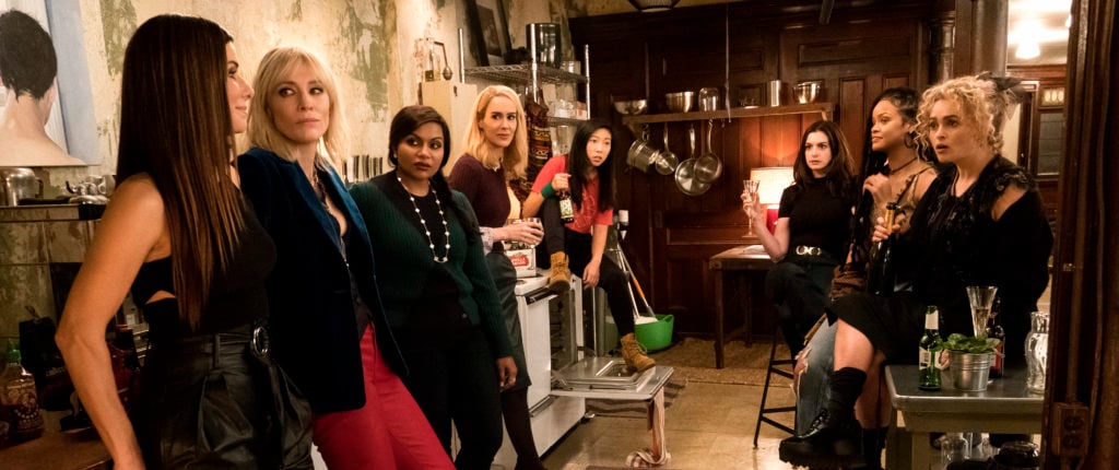 Sandra Bullock as Debbie Ocean, Cate Blanchett as Lou, Mindy Kaling as Amita, Sarah Paulson as Tammy, Awkwafina as Constance, Anne Hathaway as Daphne Kluger, Rihanna as Nine Ball and Helena Bonham Carter as Rose in Warner Bros. Pictures' and Village Roadshow Pictures' <em>Ocean's 8</em>. Film still courtesy of Barry Wetcher ©2018 Warner Bros. Entertainment Inc.