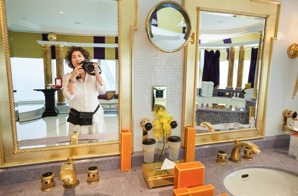 Lauren Greenfield photographs in the Presidential Suite at the Burj Al Arab hotel, Dubai, UAE, 2009. Featured in Lauren Greenfield's <em>Generation Wealth</em>. Photo courtesy of Amazon Studios ©Lauren Greenfield, all rights reserved.