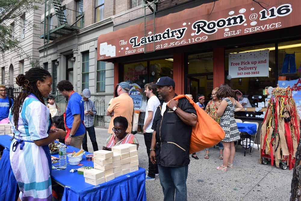 Neighbors gathering at a sidewalk art-making workshop at The Laundromat Project's Field Day 2015 in Harlem. Photo by Ray Llanos; Courtesy The Laundromat Project