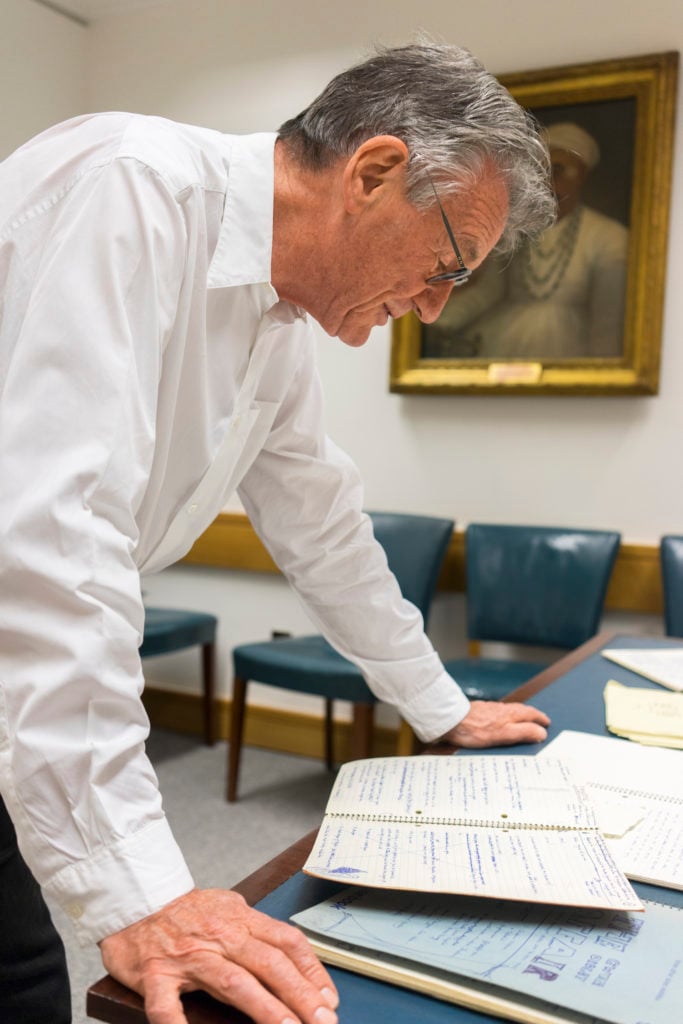 Michael Palin pages through his Monty Python archive at the British Library. Photo by Tony Antoniou, courtesy of the British Library.