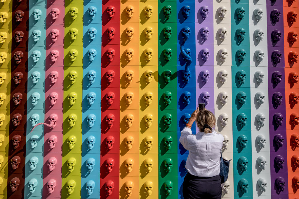 A woman takes a photograph of artwork by Ahmet Gunestekin on display at Contemporary Istanbul on September 20, 2018 in Istanbul. Photo by Chris McGrath/Getty Images.