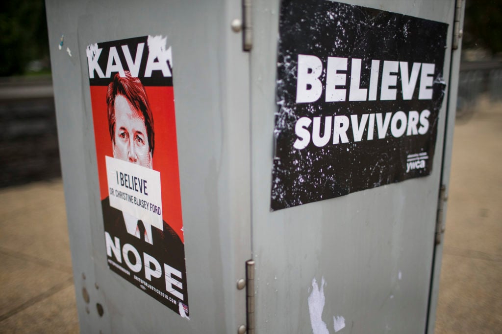 Signs protesting against Supreme Court Nominee Brett Kavanaugh, including Tracie Ching's <em>Kavanope</em> poster, are pictured near the US Supreme Court on September 27, 2018 in Washington, DC. Photo by Zach Gibson/Getty Images.