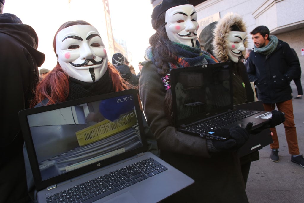Activists wearing Guy Fawkes masks, favored by the notorious hacker network known as Anonymous, during a demonstration in Madrid, Spain. (Photo by Mario Roldan/SOPA Images/LightRocket via Getty Images)