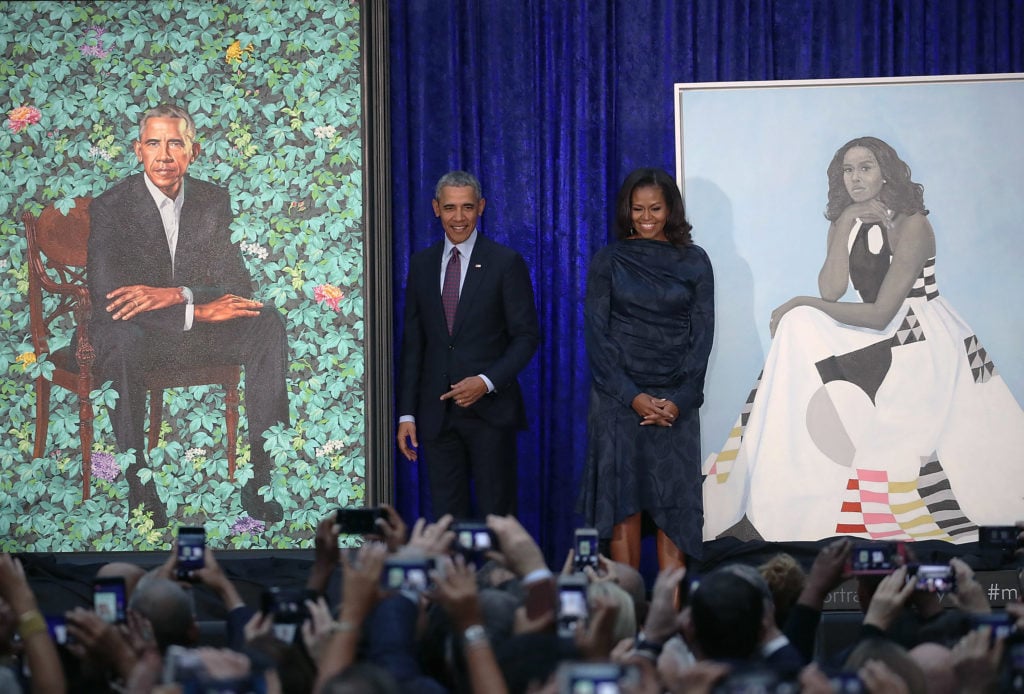 Former U.S. President Barack Obama and former first lady Michelle Obama stand next to their unveiled portraits at the Smithsonian's National Portrait Gallery. Photo by Mark Wilson/Getty Images.