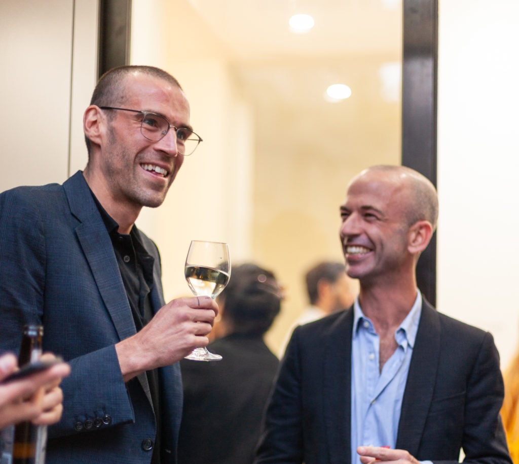 Harold Ancart, left, at the opening of "Freeze" (2018). Photo by Justyna Fedec courtesy David Zwirner.
