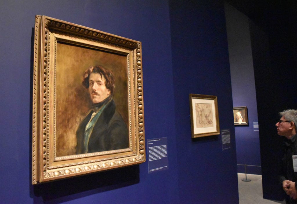A visitor looks at Eugène Delacroix's self-portrait at the Metropolitan Museum. Image courtesy Ben Davis.