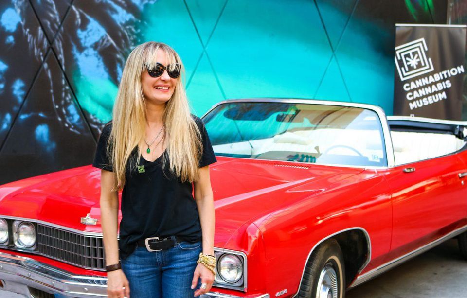 Hunter S. Thompson’s widow, Anita Thompson, with his 1973 Chevrolet Caprice at the Cannibition Cannabis Museum, where it is on loan. Photo courtesy of Cannibition.