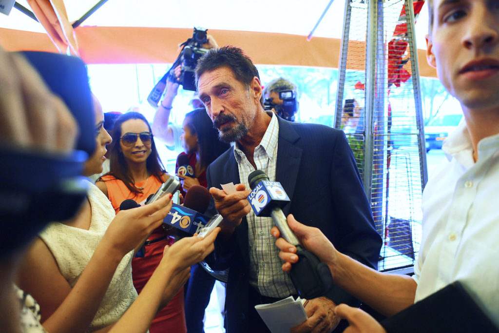 John McAfee talks to the media in Miami Beach after arriving from Guatemala on December 13, 2012. McAfee was a 'person of interest' in the fatal shooting of his neighbor in Belize and turned up in Guatemala after a month on the run. Photo by Joe Raedle/Getty Images.