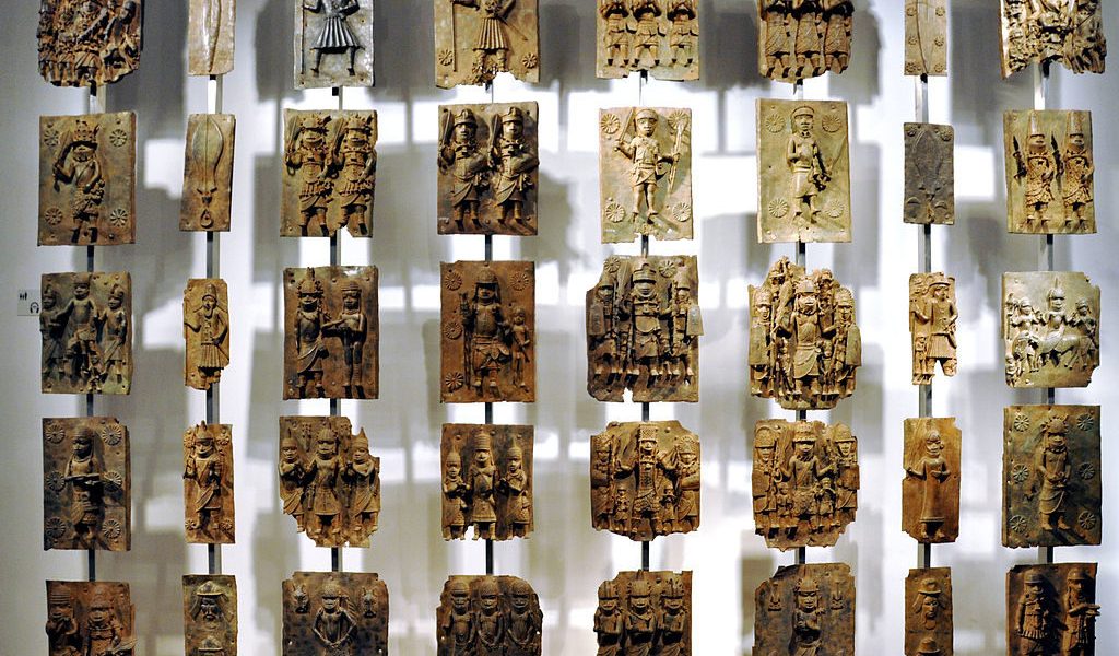 Cast brass plaques from Benin City at British Museum. Photo by Andreas Praefcke, public domain.