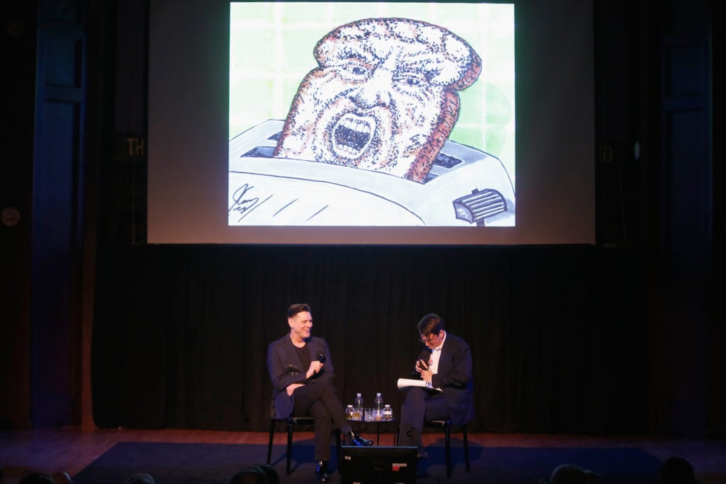Jim Carrey and Colin Stokes with one of Carrey's anti-Donald Trump political cartoons during the 2018 New Yorker Festival. Photo by Thos Robinson/Getty Images for the New Yorker.