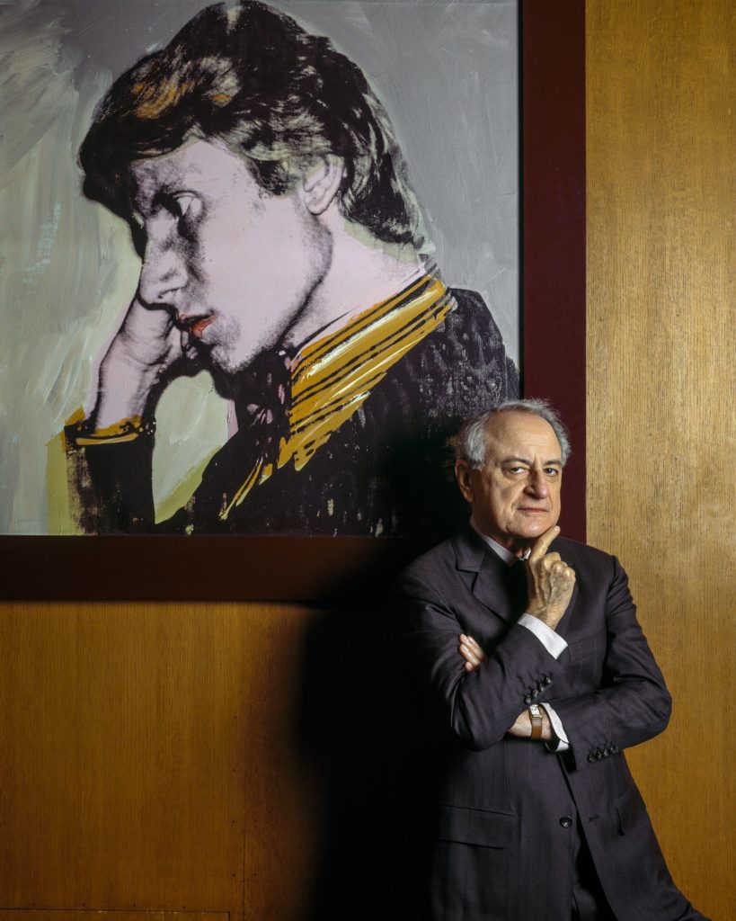 Pierre Bergé in his office in 1999 with an Andy Warhol portrait of Yves Saint Laurent. Photo courtesy of Sotheby's Paris, ©Derek Hudson/Getty Images/the Andy Warhol Foundation for the Visual Arts, Inc.