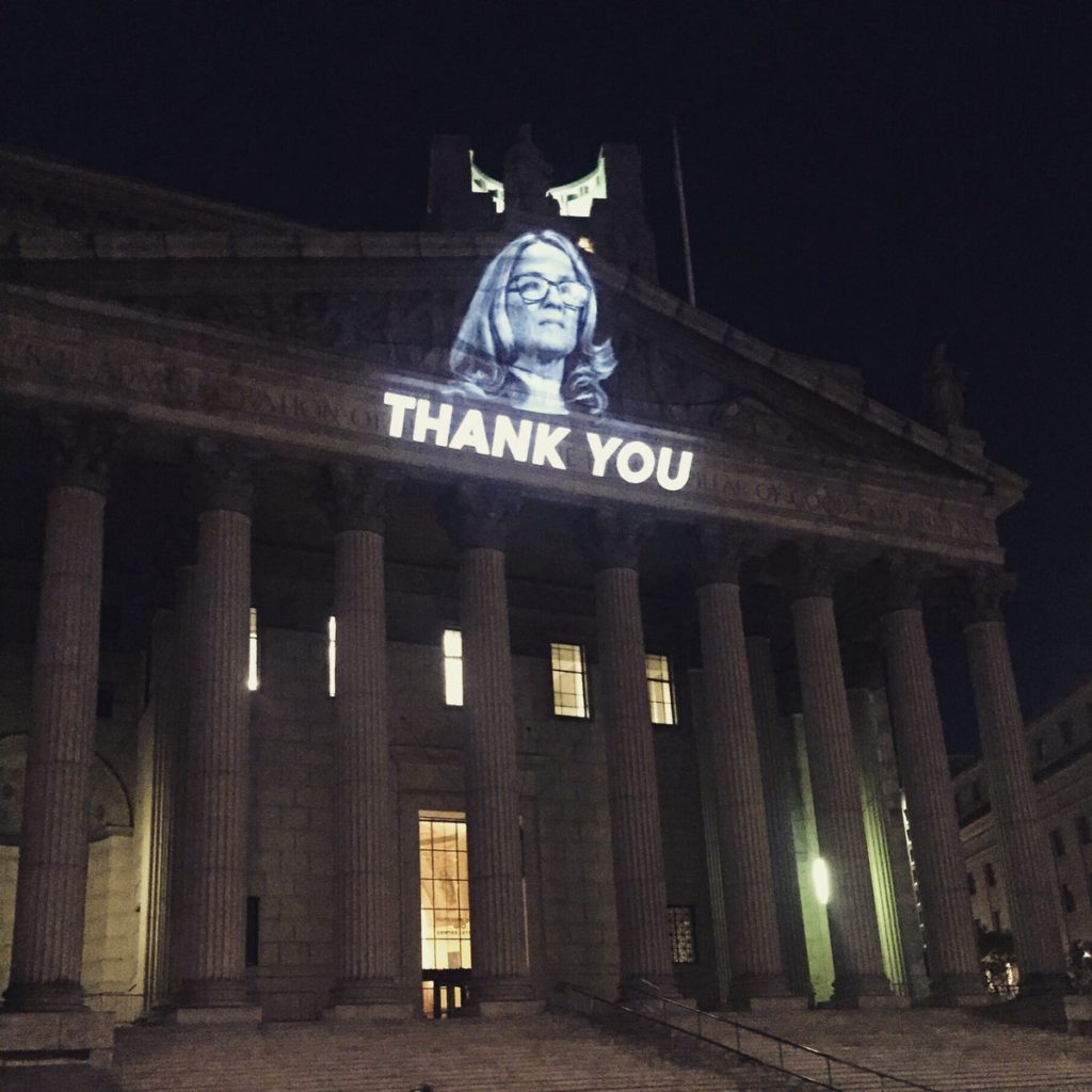 The Illuminator projected this image of Christine Blasey Ford onto the New York Supreme Court building to honor her testimony against US Supreme Court nominee Judge Brett Kavanaugh, who she claims sexually assaulted her. Photo courtesy of the Illuminator.