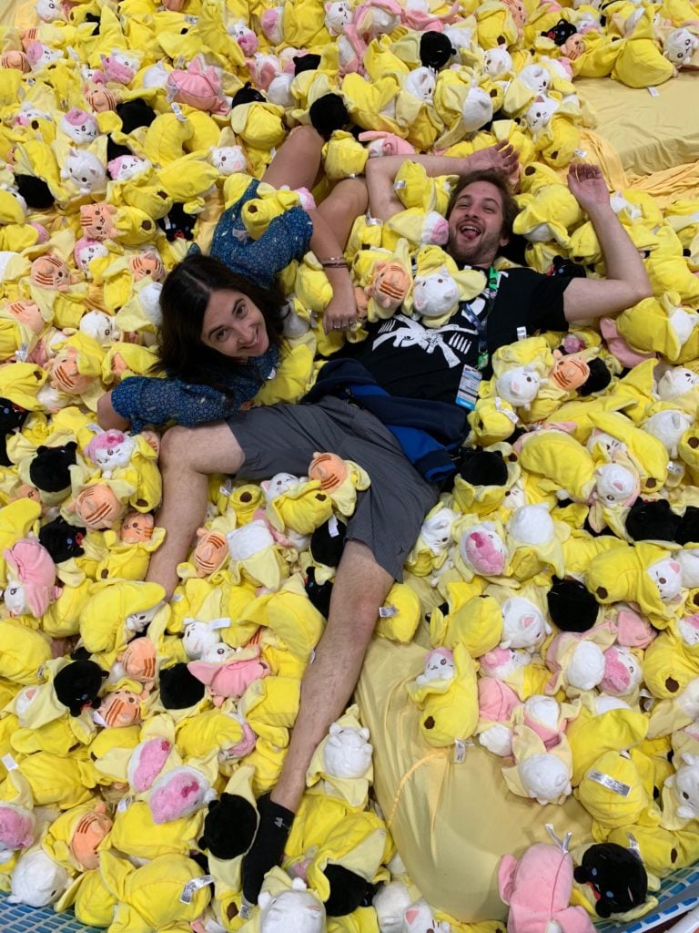 The author and her brother posing in <em>Bananya</em> ball pit at New York Comic Con. Photo courtesy of Sarah Cascone.