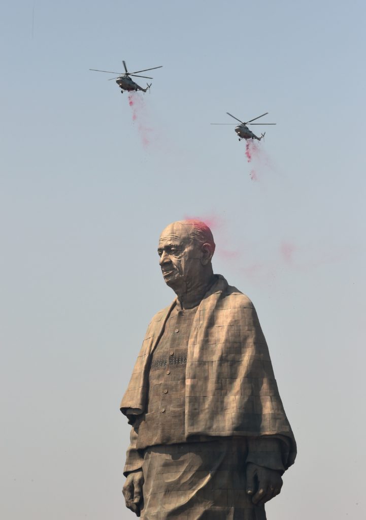 Indian Air Force helicopters shower rose petals on the the Statue Of Unity, the world's tallest statue, dedicated to Indian independence leader Sardar Vallabhbhai Patel. Photo by Sam Panthaky/AFP/Getty Images.
