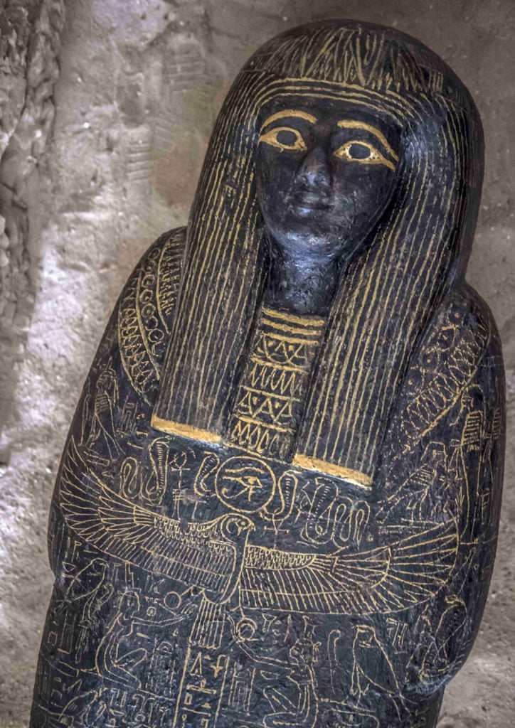 A carved black wooden sarcophagus inlaid with gilded sheets discovered by an Egyptian archaeological mission at the site of Tomb TT28, or Thaw-Irkhet-If, at Al-Assasif necropolis on the west bank of the Nile north of the southern Egyptian city of Luxor. Photo by Khaled Desouki/AFP/Getty Images.