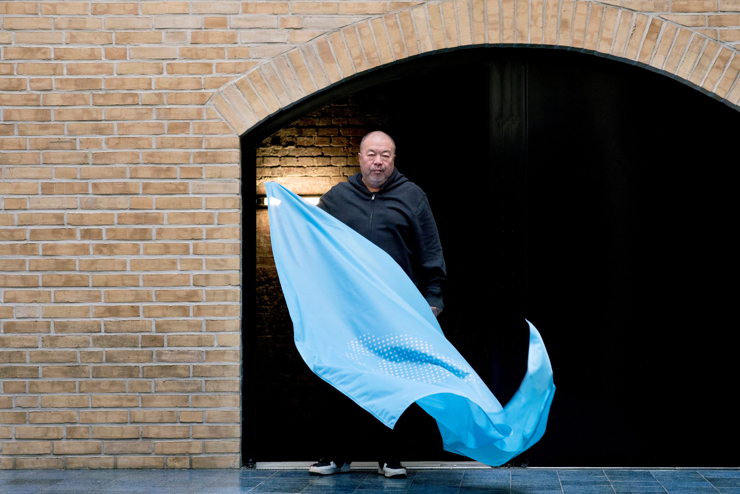 Ai Weiwei at his Berlin studio with his flag to mark the 70th anniversary of the Declaration of Human Rights. Photo by Camilla Greenwell.