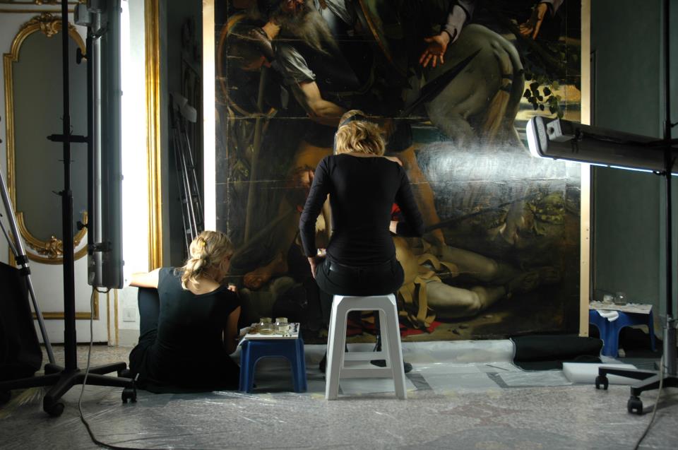 Valeria Merlini and a collaborator during the restoration of Caravaggio's <em>Conversion of Saul</em>. Photo courtesy of Studio Merlini Storti. 