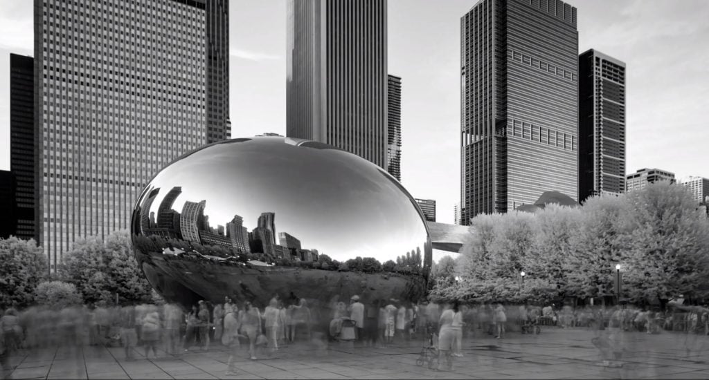 Screenshot of Anish Kapoor's <em>Cloudgate</em> in the NRA's "Clenched Fist of Truth" video.