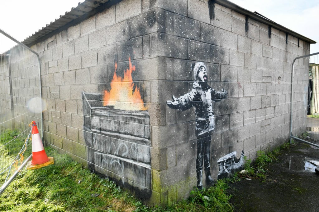 Banksy's mural on a garage wall in, Port Talbot, south Wales. Photo by Ben Birchall PA/Getty Image.
