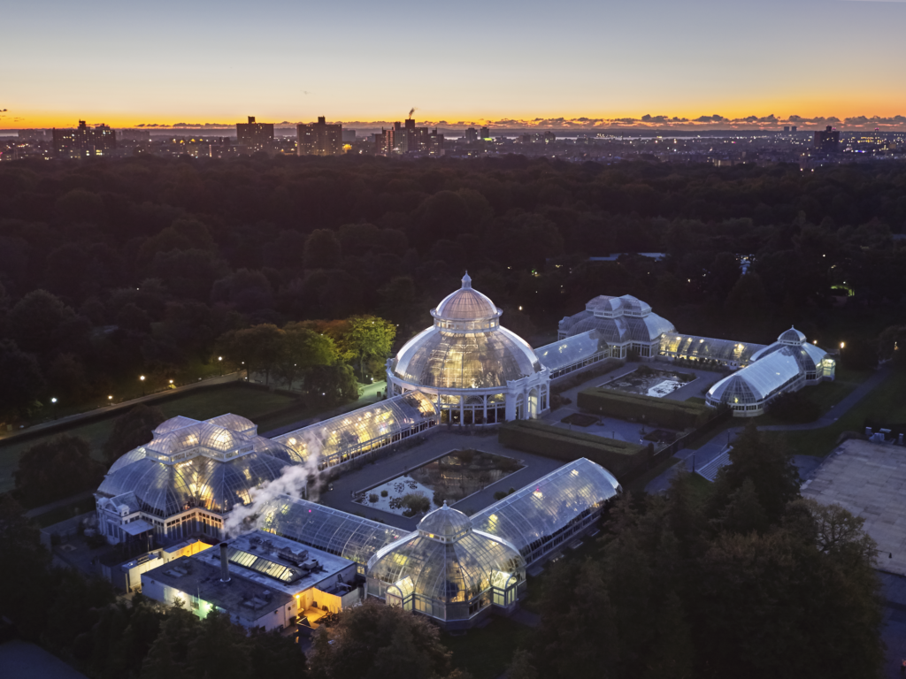An aerial view of the New York Botanical Garden's conservatory at dusk. Photo © Robert Benson Photography courtesy of NYBG.