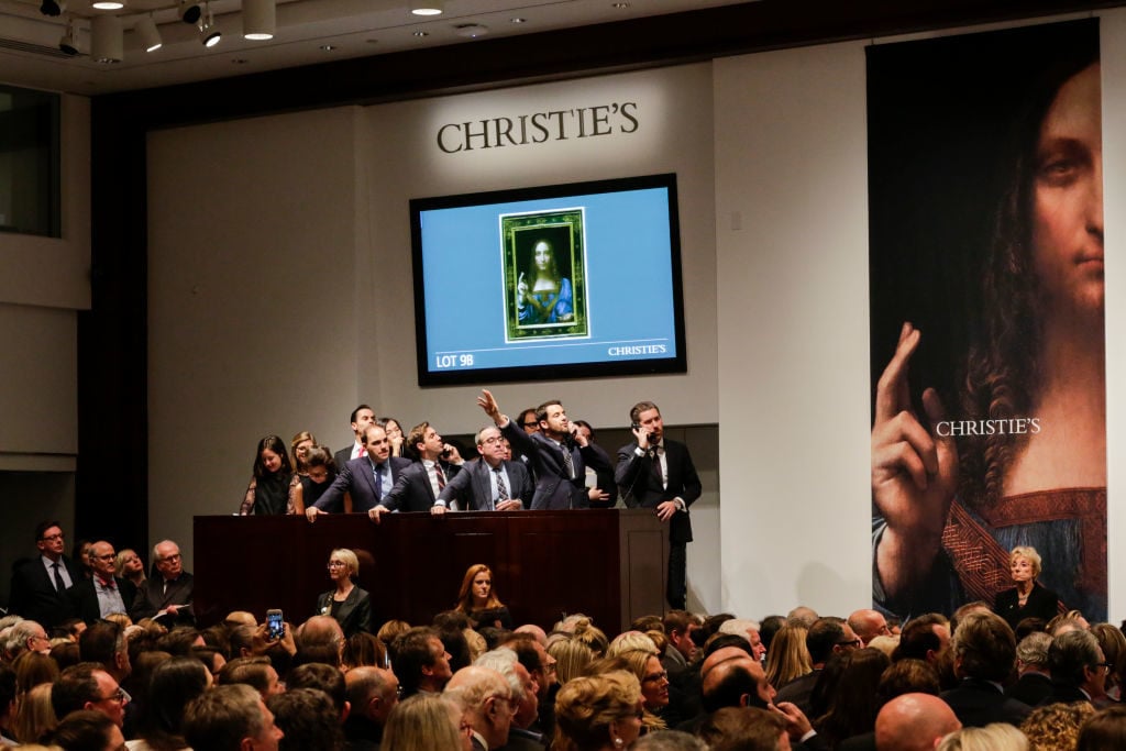 Agents speak on their phones with their clients while bidding on at the auction of Leonardo da Vinci's Salvator Mundi during the Post-War and Contemporary Art evening sale at Christie's on November 15, 2017 in New York City. Photo by Eduardo Munoz Alvarez/Getty Images