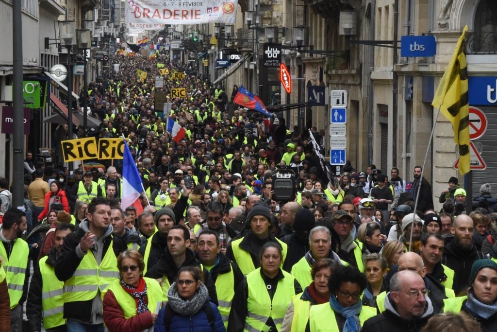Protesters march on Rue Sainte-Catherine in Bordeaux, southwestern France, as they take part in an anti-government demonstration called by the "yellow vests" (gilets jaunes) movement on January 26, 2019. Photo courtesy Mehdi Fedouach/AFP/Getty Images.
