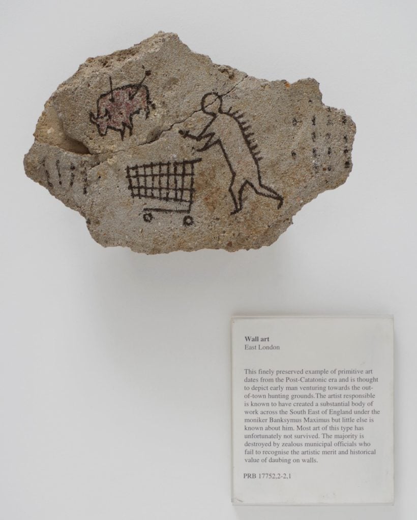 Banksy, <em>Peckham Rock</em> (2005). The piece was secretly installed at at the British Museum in 2005, and went undetected for days. Photo courtesy of Banksy and Pest Control.