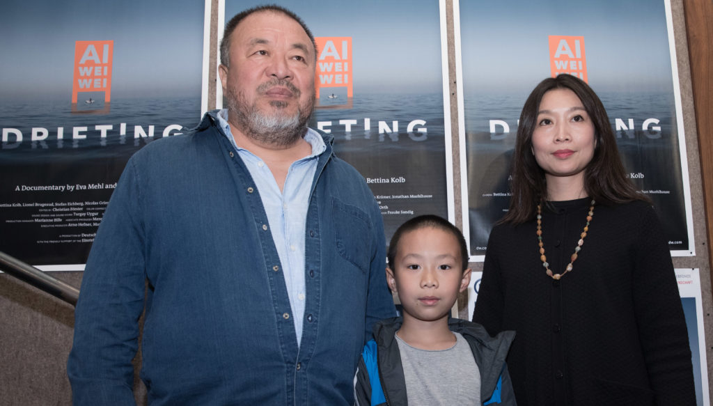 Chinese artist Ai Weiwei, his son Lao Ai, and his girlfriend Wang Fen at the Berlin premiere of the documentary film <em>Ai Weiwei Drifting</em> in 2017. Photo by Jörg Carstensen/dpa/Getty Images.