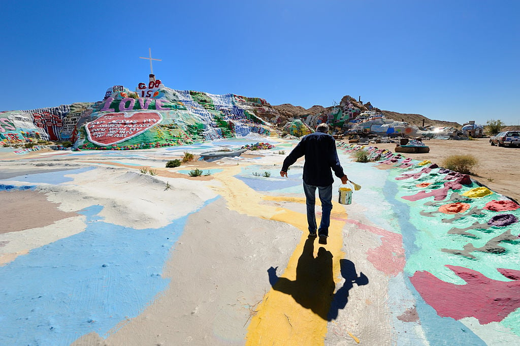 Leonard Knight at work on his art installation, Salvation Mountain. Photo: by Christopher Morris/Corbis via Getty Images.