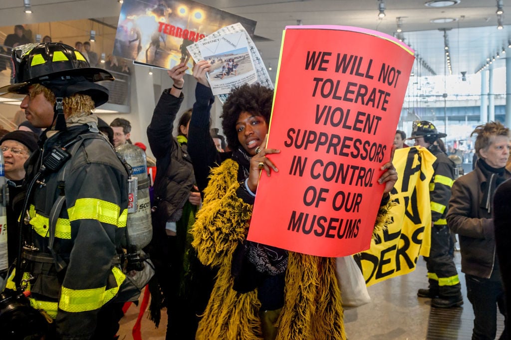 Activists protesting against the continued presence of Warren B. Kanders on the board of the Whitney Museum. Photo by Erik McGregor/Pacific Press/LightRocket via Getty Images.