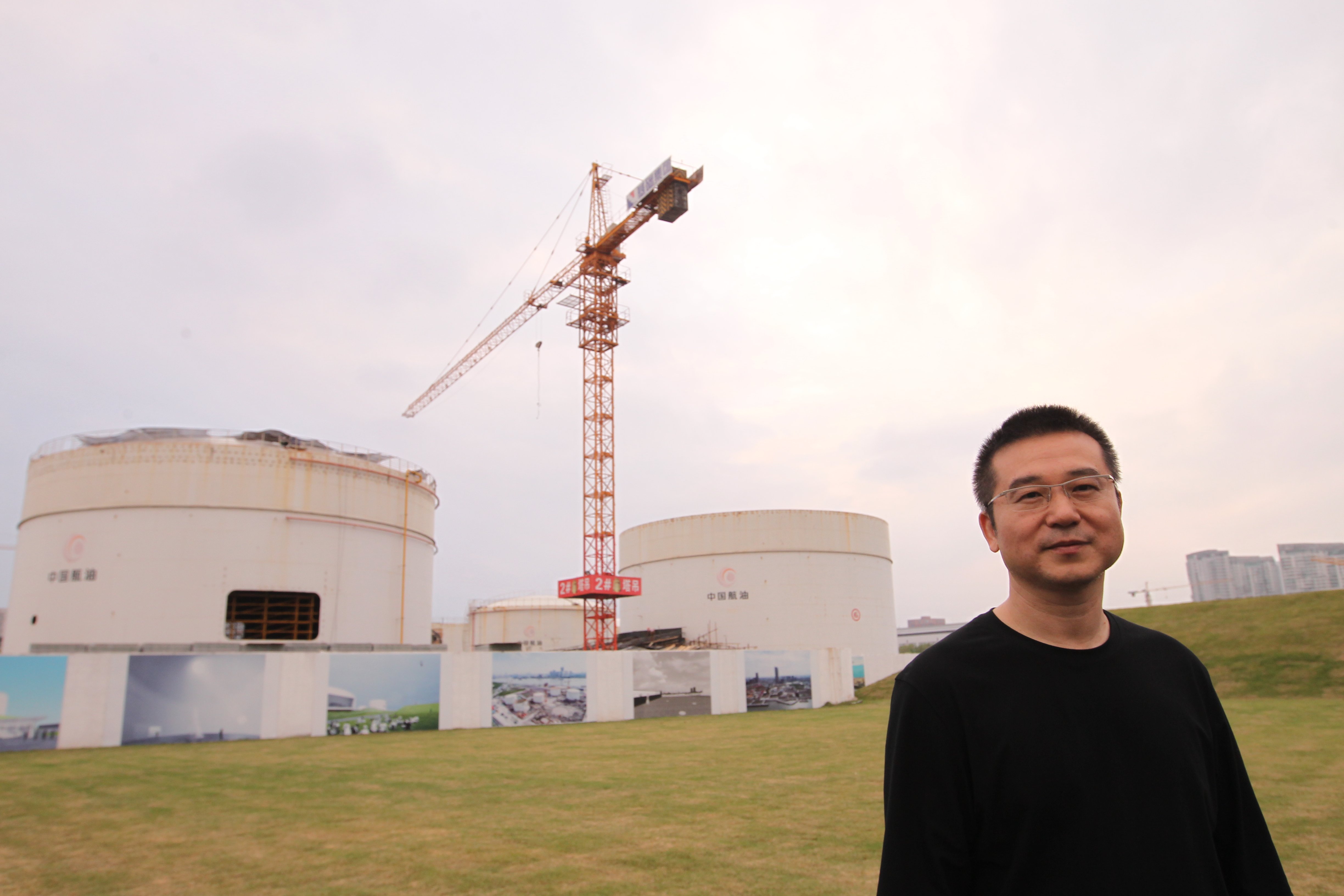 Collector Qiao Zhibing in front Tank Shanghai. Photo by Simon Song/South China Morning Post via Getty Images.