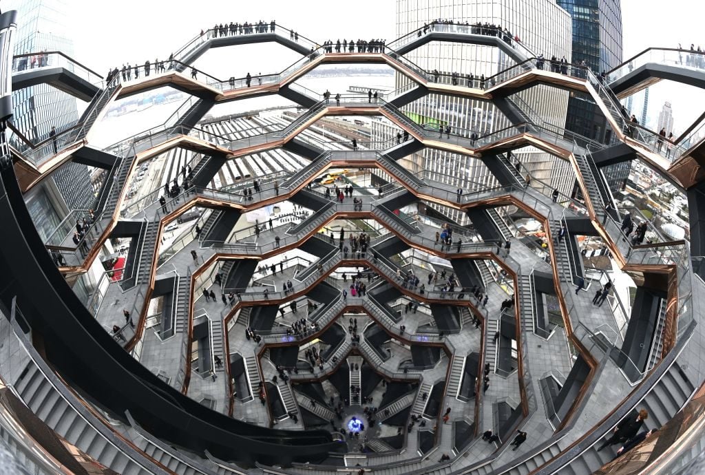 People take a inaugural walk up the urban landmark, temporarily known as <em>Vessel</em> during the the opening of New Yorks newest neighborhood, Hudson Yards March 15, 2019. Photo by Timothy A. Clary//AFP/Getty Images.