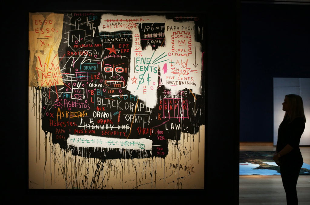 Jean-Michel Basquiat's<em> Museum Security (Broadway Meltdown)</em> is displayed at Christie's London in 2013. Photo by Peter Macdiarmid/Getty Images.