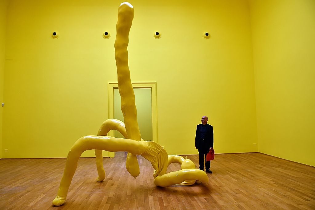 A visitor looks at a creation by British artist Sarah Lucas at the pavilion of Great Britain during the 56th International Art Exhibition in Venice. AFP Photo / Gabriel Bouys.