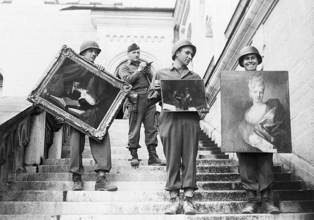 Soldiers retrieving three paintings from the Neuschwanstein Castle in Fussen, Germany, where they were a part of the collection looted by the Nazis from conquered countries. Photo: Getty Images.