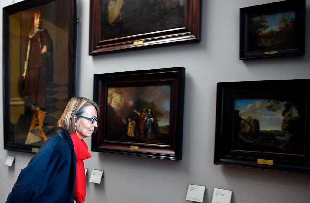 Then-French Culture Minister Françoise Nyssen investigates paintings at the Louvre whose owners have not yet been identified. Photo: Alain Jocard/AFP/Getty Images.