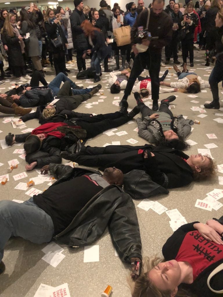 Protestors at the Guggenheim Museum stage a "die-in" to protest Sackler funding. Photo: Caroline Goldstein.