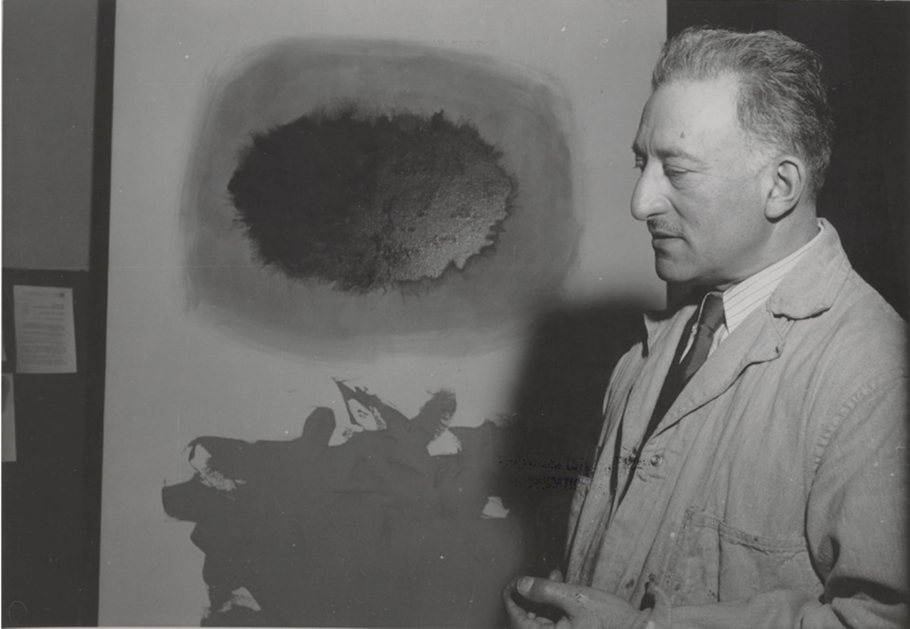 Adolph Gottlieb in his 23rd Street studio (1958). Shown in background: <em>POSITIVE</em> (1958). ©Adolph and Esther Gottlieb Foundation.