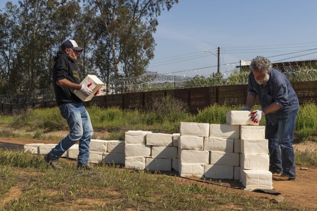 Cosimo Cavallaro is building a wall of cotija cheese along the US Mexico border. Photo by Alan Schaffer, courtesy of the artist.