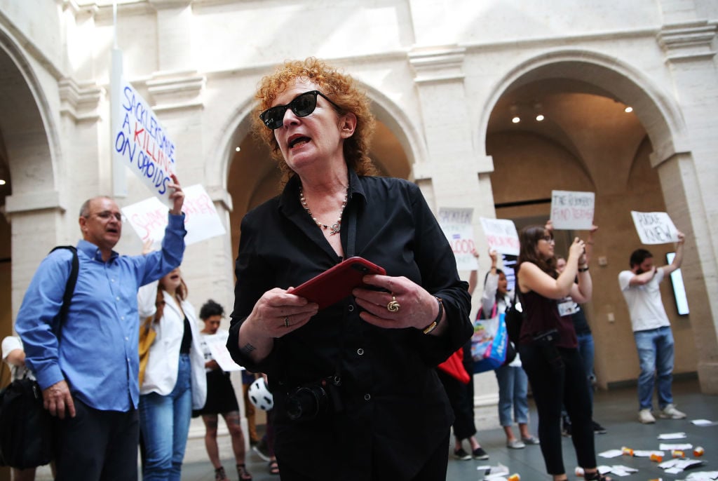 Nan Goldin leads a demonstration at the Harvard Art Museums in Cambridge, MA on July 20, 2018 to protest the benefactor of the Sackler Art Museum. Photo by Erin Clark for The Boston Globe via Getty Images.