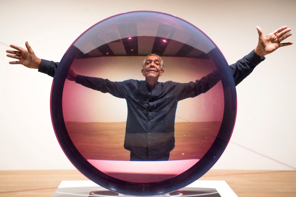 Artist Fred Eversley with Untitled (Parabolic Lens) (1971), photo by Victoria Jones/PA Images via Getty Images.