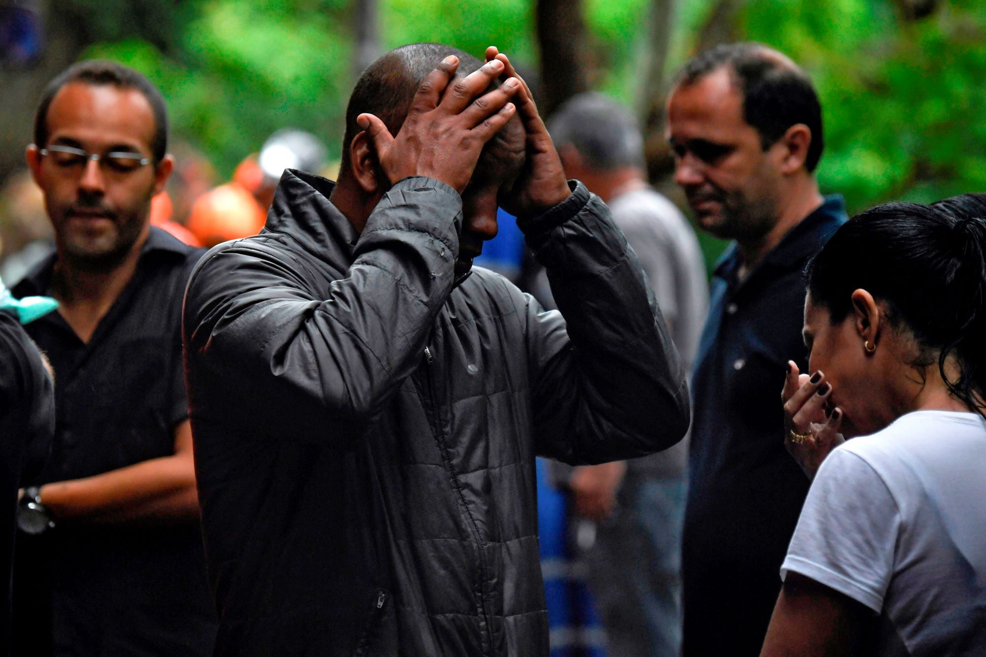 Relatives mourn after a fatal mudslide caused by heavy rains in Rio de Janeiro, Brazil, on April 9. Photo by Mauro Pimentel AFP/Getty Images.